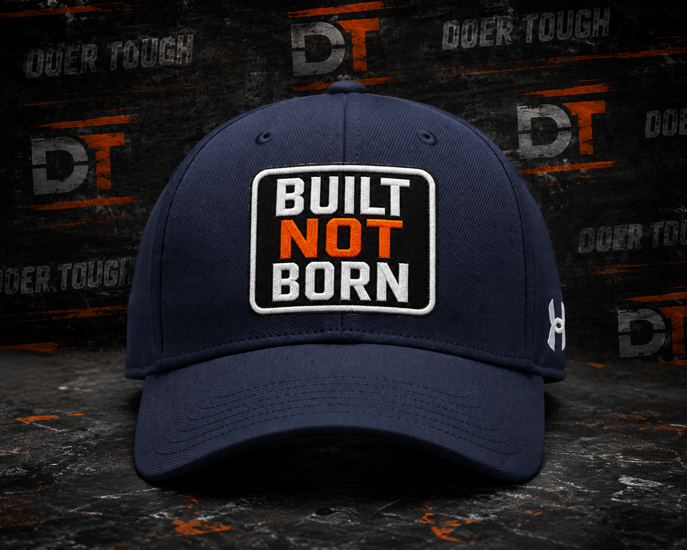 Doer Tough performance cap with BUILT NOT BORN patch on an Under Armour blank