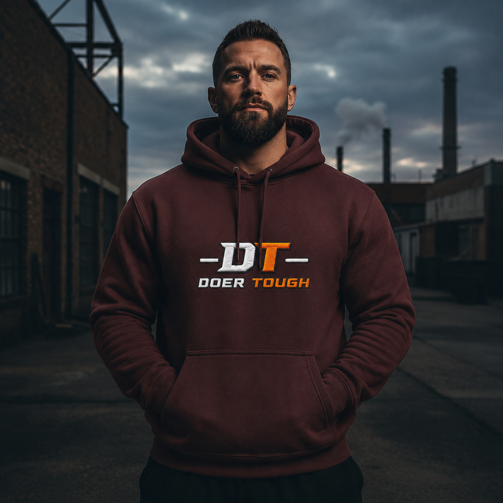 Doer Tough Heavyweight Hoodie — maroon lifestyle mockup, man in industrial setting